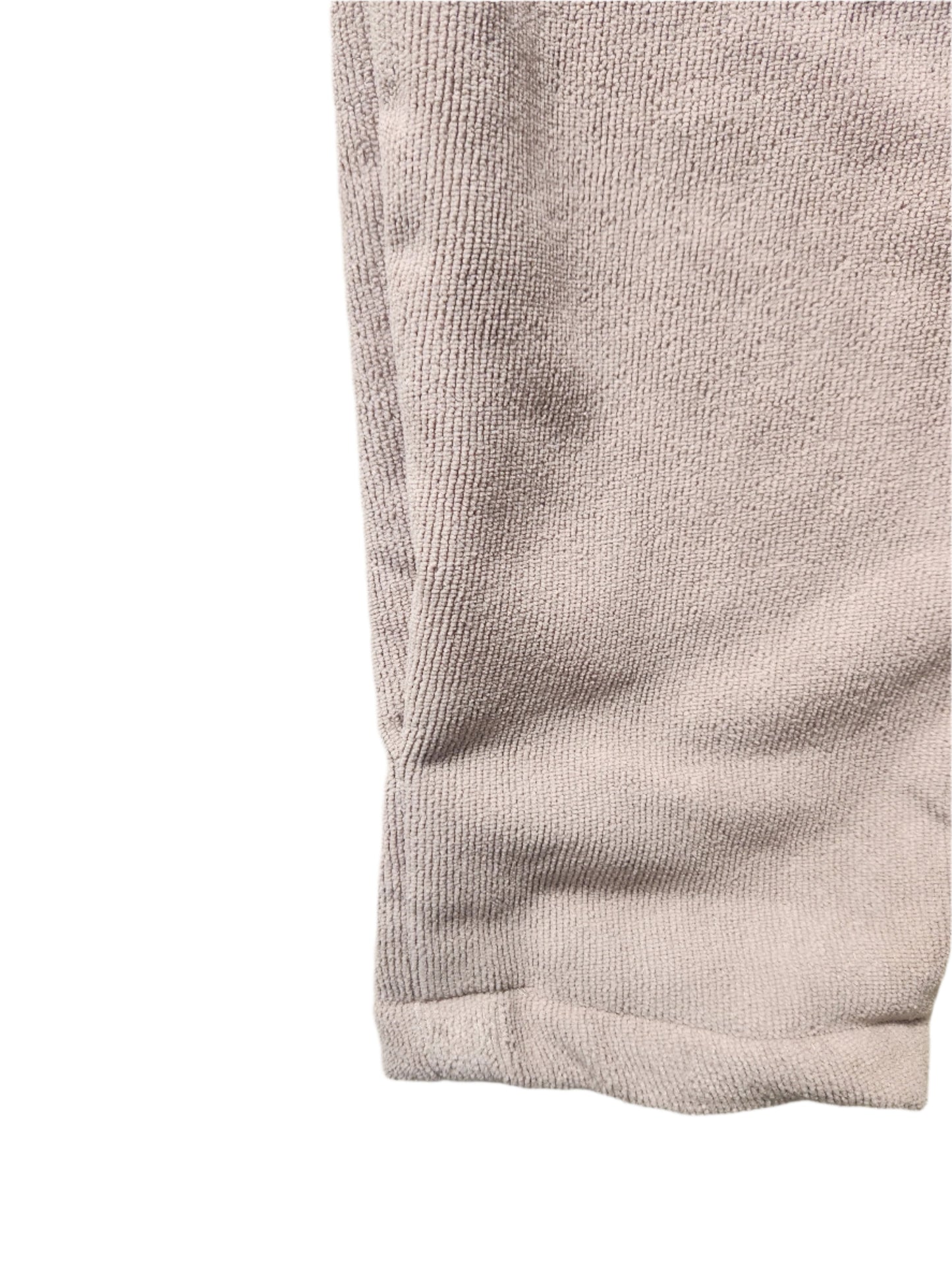 Close-up of a textured fabric with a visible seam on a light background